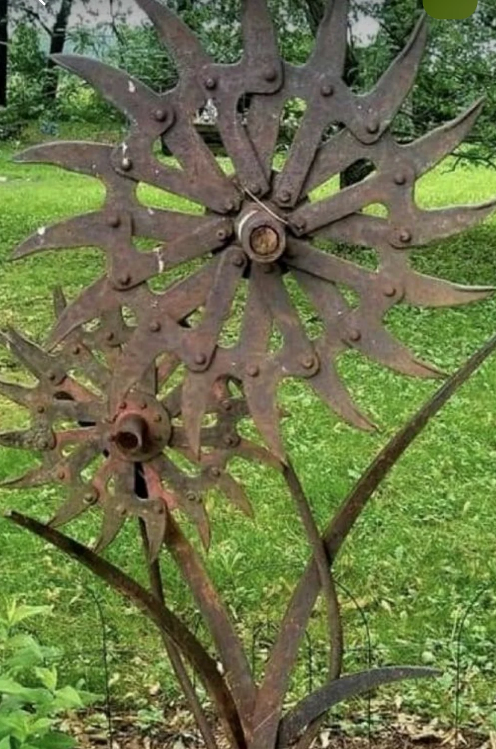 Branching metal sculpture with sunburst-style flowers