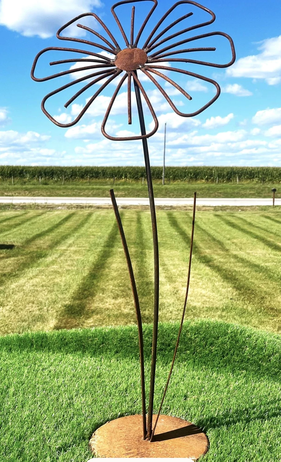 Tall open wire petal sculpture in grass